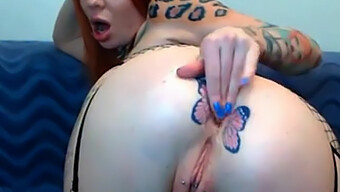 Tattooed Redhead Gets Rough Fistful Of Butterflies On Webcam